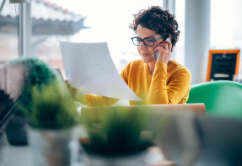 Photo of mature women using smart phone in the office